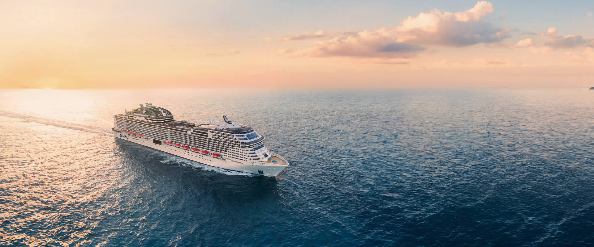 Cruise ship sailing on calm sea with sunset and open sky above | MSC Cruises