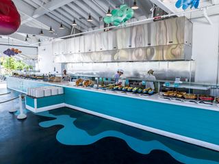 Bright buffet area with contemporary decor and vibrant seating for visitors | MSC Cruises