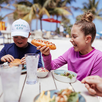 Children enjoying a meal together by the beach at Ocean Cay MSC Marine Reserve | MSC Cruises