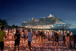 MSC cruise ship docked near Ocean Cay beach with crowds enjoying the night | MSC Cruises