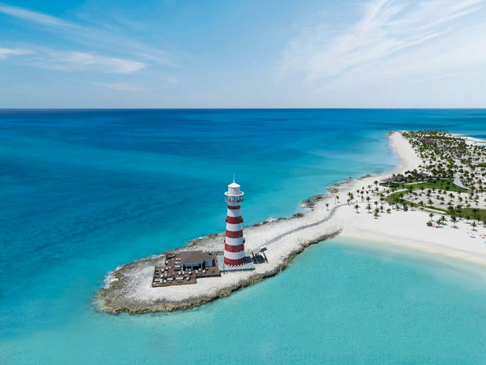 Stunning view of a beach, turquoise sea and lighthouse at Ocean Cay MSC Marine Reserve | MSC Cruises