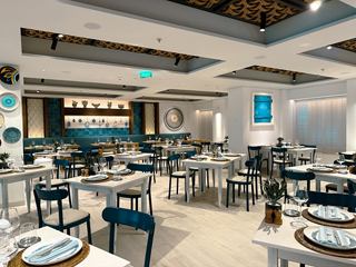 Greek restaurant with inviting tables and chairs offering a welcoming setting for guests | MSC Cruises