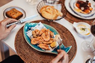 Greek taverna serving fresh seafood with pita bread and dip in a welcoming atmosphere | MSC Cruises