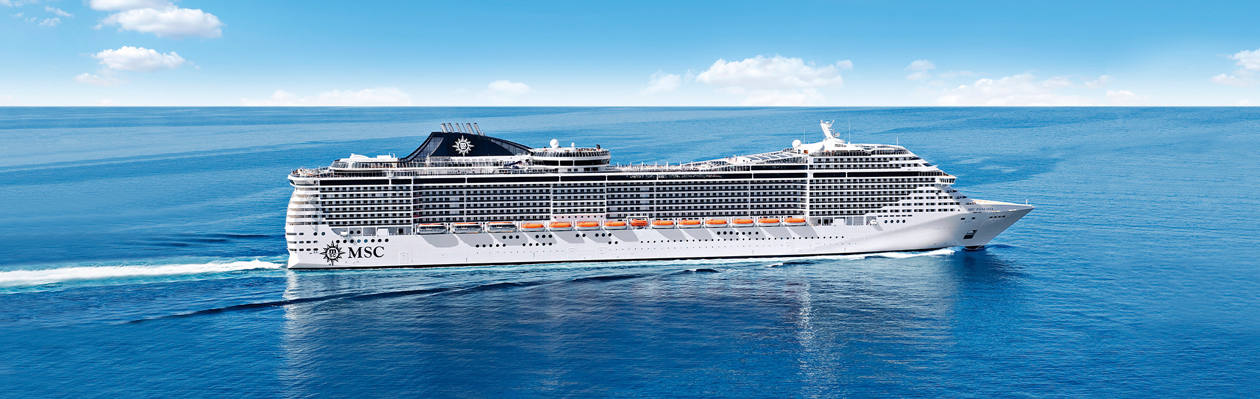 The MSC Fantasia cruise ship sails across calm blue waters beneath a clear sky | MSC Cruises