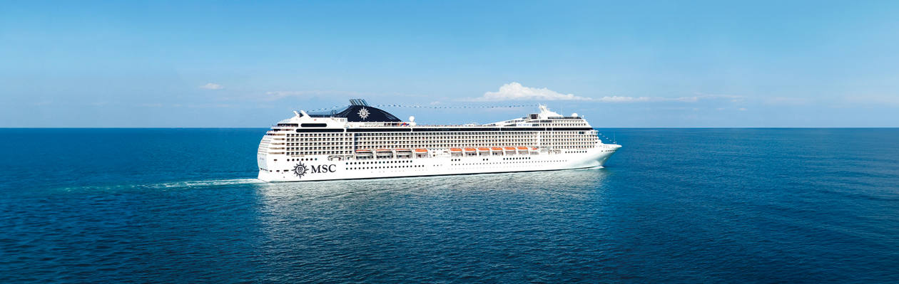 Cruise ship sails across calm blue seas beneath a clear sky | MSC Cruises