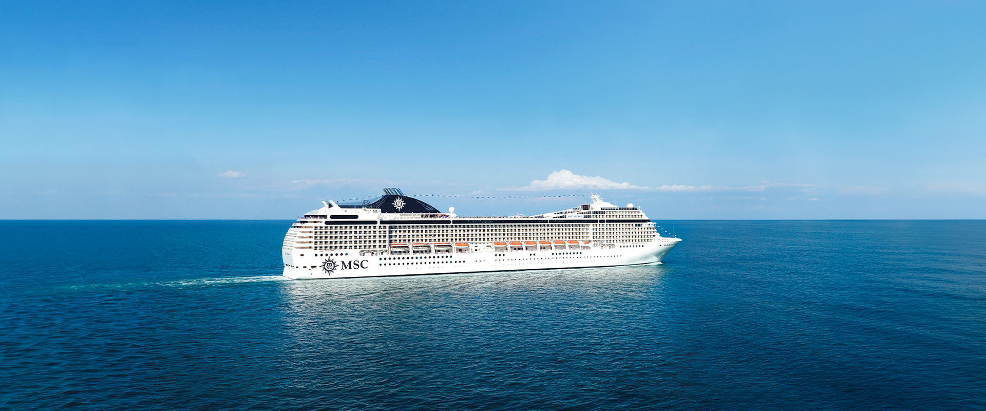 Cruise ship sails across calm blue seas beneath a clear sky | MSC Cruises