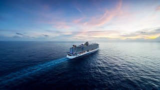 MSC Cruises ship sails across the open sea under a vibrant sunset sky | MSC Cruises