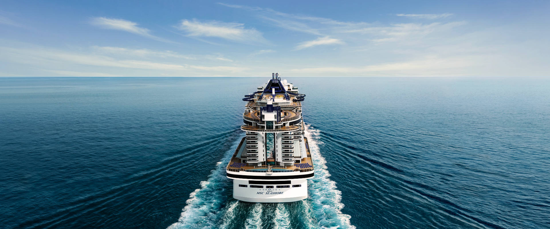 MSC Seashore sails across open waters beneath a clear blue sky | MSC Cruises