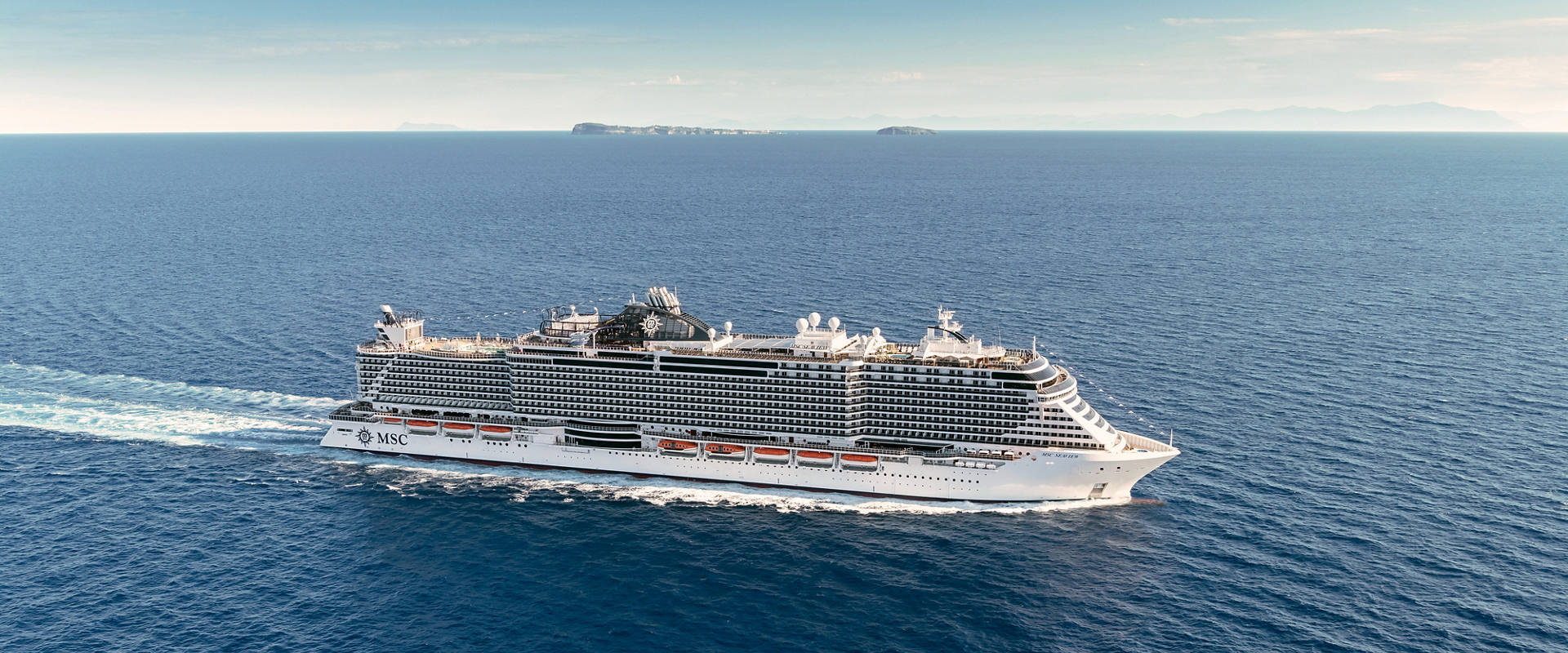 MSC Seaview cruise ship sails across open sea beneath a clear blue sky | MSC Cruises
