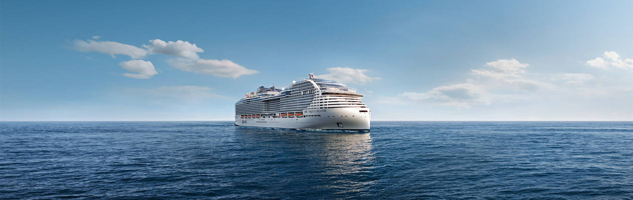 A cruise ship sails across calm blue waters under a clear sky | MSC Cruises