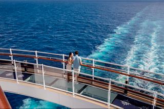 A guest stands on the cruise ship deck embracing the stunning ocean view | MSC Cruises