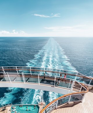 The glass bridge of the cruise ship extends towards the bright blue sea at the horizon | MSC Cruises