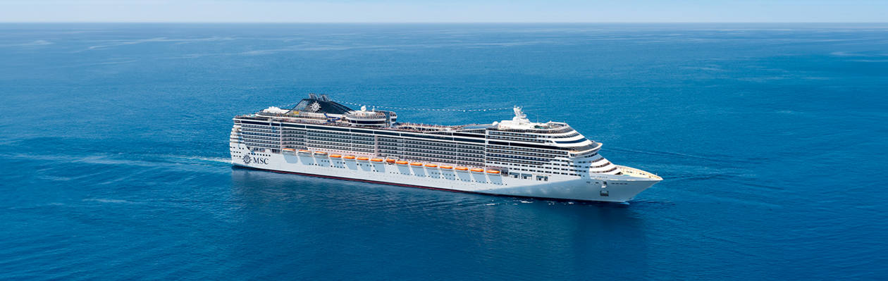 MSC Cruises ship sails across a tranquil blue sea beneath a bright sky | MSC Cruises