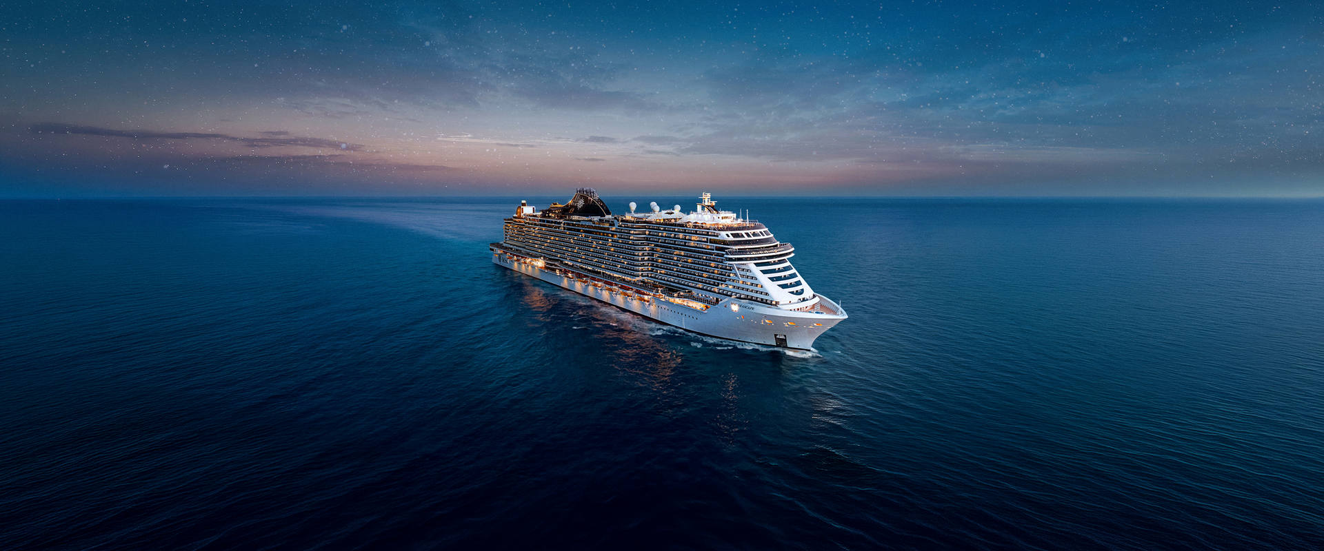 MSC Seascape cruise ship gliding across calm waters at sunset | MSC Cruises
