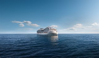 A modern cruise ship sails across calm blue waters beneath a clear sky | MSC Cruises