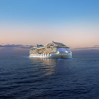 MSC World Atlantic sails across the sea at dusk with gentle lights glimmering on the horizon | MSC Cruises