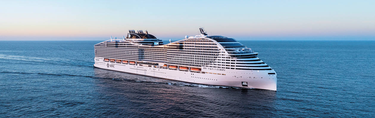 A cruise ship sails across calm waters beneath a clear blue sky | MSC Cruises