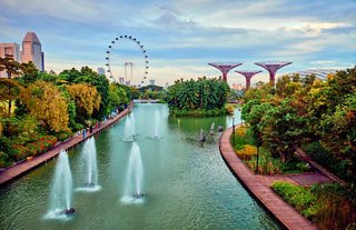 Gardens by the Bay in Singapore featuring fountains, a lake and a panoramic wheel | MSC Cruises