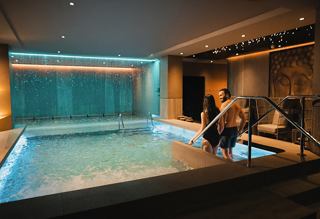 Indoor pool with a tranquil ambiance and inviting lounge areas for relaxation | MSC Cruises