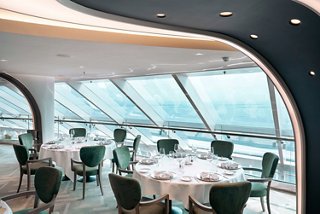 MSC Yacht Club restaurant with glass walls and panoramic sea views aboard the ship | MSC Cruises