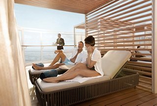 Guests relax under a shaded cabana by the pool with sea views and attentive service | MSC Cruises