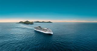 Cruise ship travels toward islands across a calm blue sea under a clear sky | MSC Cruises