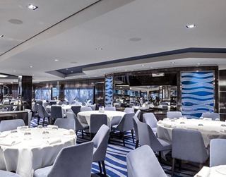 A spacious and elegant dining area with modern decor and well-set tables ready for guests | MSC Cruises