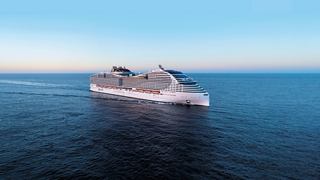 A majestic cruise ship sailing through calm waters under a clear blue sky | MSC Cruises