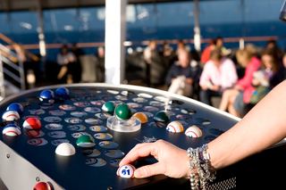 Guests enjoy outdoor bingo on MSC Splendida, engaging in fun and entertainment with a beautiful sea backdrop | MSC Cruises