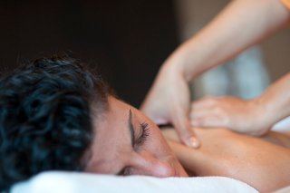 A person receiving a relaxing massage in the tranquil setting of MSC Aurea Spa | MSC Cruises
