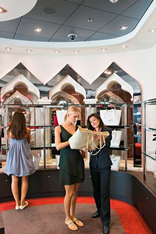 Guests enjoy shopping together at La Boutique on MSC Divina, exploring a variety of products and experiences | MSC Cruises