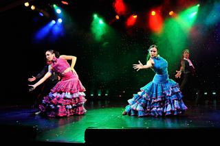 Two dancers in vibrant costumes perform a captivating dance on stage | MSC Cruises