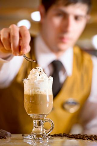 A bartender skillfully prepares a delightful drink at the bar on MSC Preziosa, showcasing exceptional service | MSC Cruises
