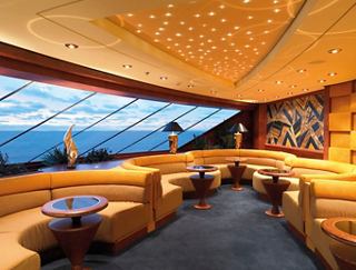 A stylish lounge area with plush seating and panoramic views, perfect for relaxation at sunset | MSC Cruises