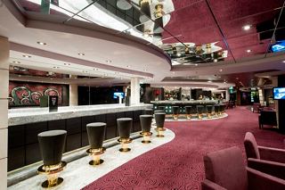 A vibrant bar area on MSC Magnifica, featuring a stylish counter and seating for relaxation and socialising | MSC Cruises