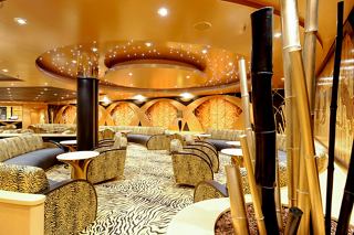 A warm and inviting view of the Tiger Bar on MSC Magnifica, featuring comfortable seating and elegant decor | MSC Cruises