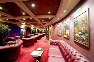 A stylish interior of the Cuba Lounge Cigar Room featuring plush seating and elegant decor | MSC Cruises