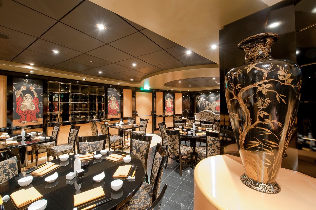 A welcoming dining area in the Oriental Plaza Restaurant on MSC Magnifica with elegant tables and chairs | MSC Cruises