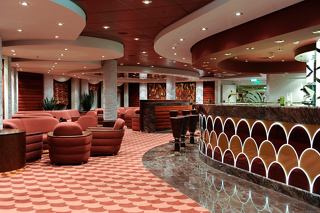 A welcoming bar area with plush seating and a stylish counter invites relaxation aboard MSC Magnifica | MSC Cruises