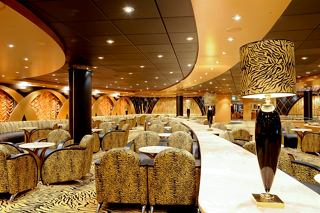 A welcoming view of the Tiger Bar inside MSC Magnifica, featuring stylish seating and warm lighting | MSC Cruises