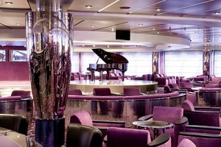 Un salon accueillant avec des sièges, une scène et un piano pour des performances en direct sur le MSC Magnifica | MSC Croisières