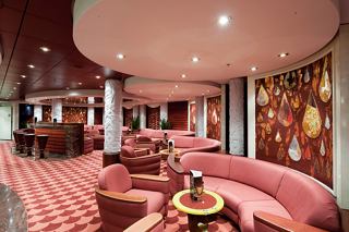 A stylish lounge area featuring comfortable seating and a warm atmosphere for relaxation and socialising | MSC Cruises