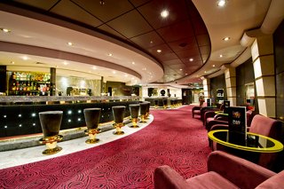 Elegant bar area on MSC Magnifica with plush seating and a welcoming atmosphere for relaxation and socialising | MSC Cruises