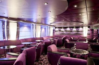 A stylish interior of L'Ametista Lounge on MSC Magnifica with plush seating and tables for relaxation | MSC Cruises