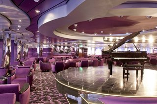 A stylish lounge with plush seating and a grand piano, perfect for enjoying live music and relaxation | MSC Cruises