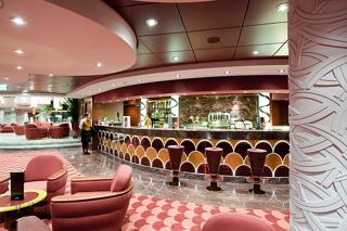 A welcoming bar area on MSC Magnifica featuring comfortable seating and a stylish counter for guests to enjoy beverages | MSC Cruises