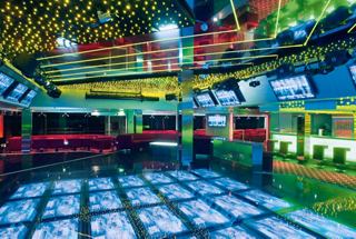 A vibrant dance floor and seating area at Q32 Disco on MSC Musica, perfect for lively entertainment and socialising | MSC Cruises
