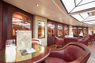 A warm and inviting view of L'Enoteca Wine Bar on MSC Musica featuring elegant seating and ambient lighting | MSC Cruises