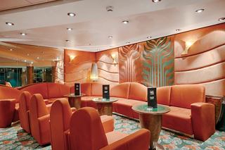 A stylish lounge area featuring comfortable sofas and armchairs, perfect for relaxation and socialising | MSC Cruises