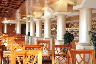 A welcoming dining area with elegant arches and columns, perfect for enjoying delightful meals | MSC Cruises